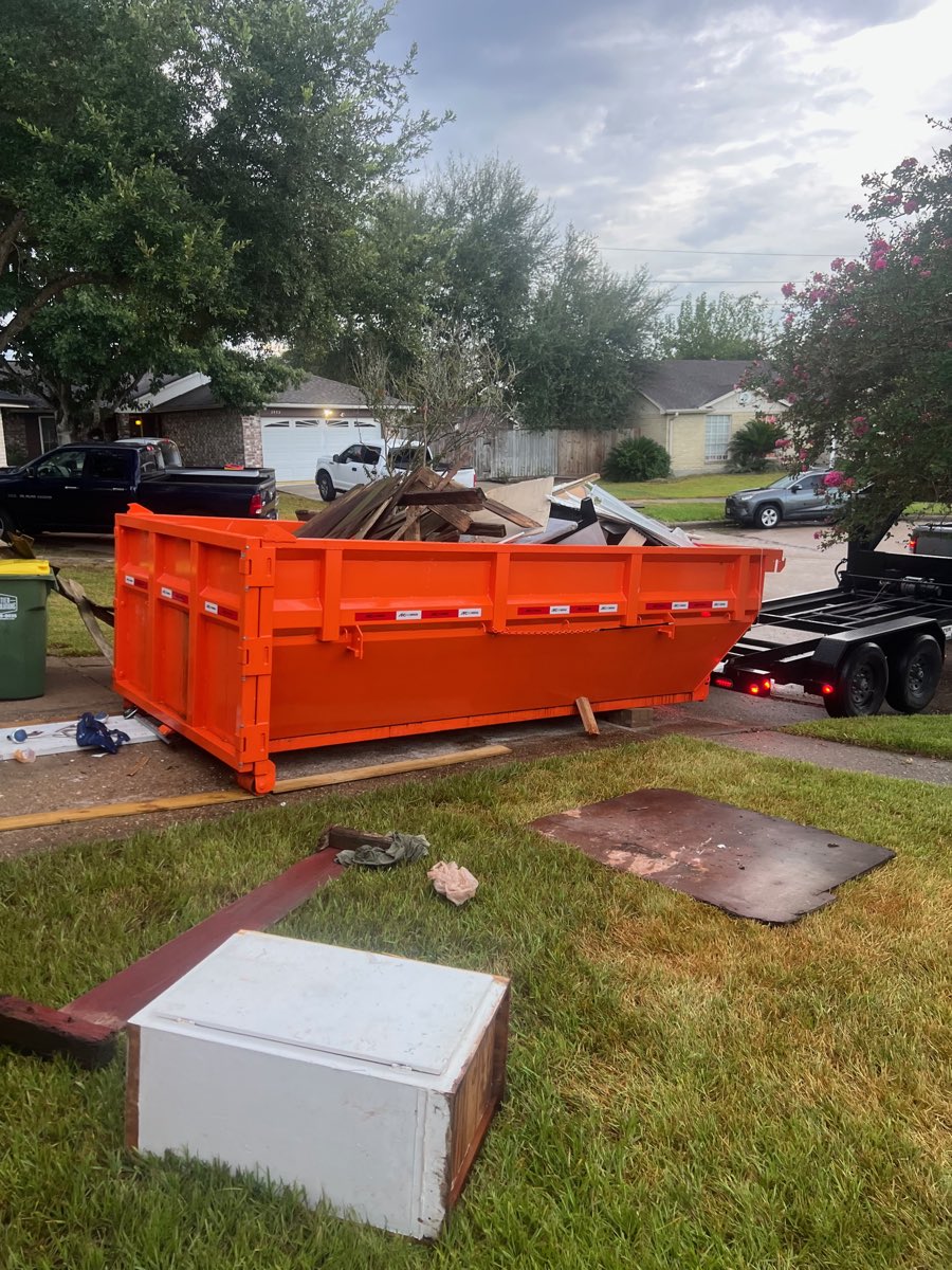 Roll-off dumpster loaded with lumber and metal tear-out debris