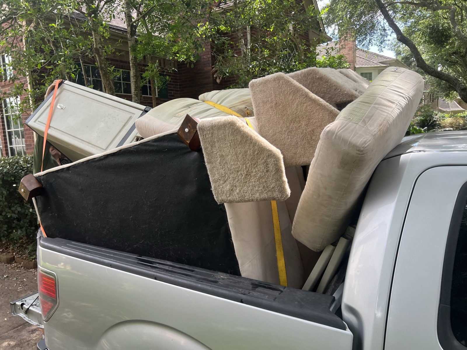 Truck bed loaded with furniture and junk for removal