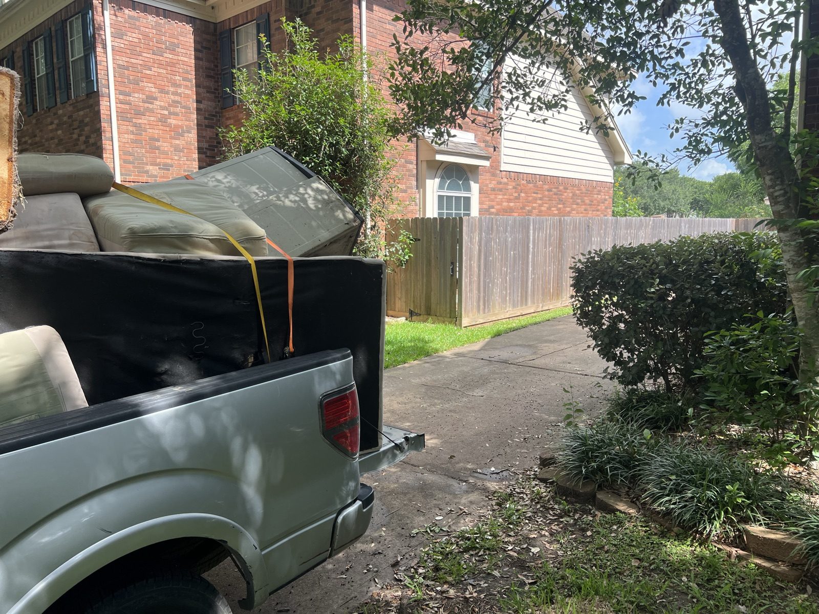 Truck bed and cleared yard on a junk removal job