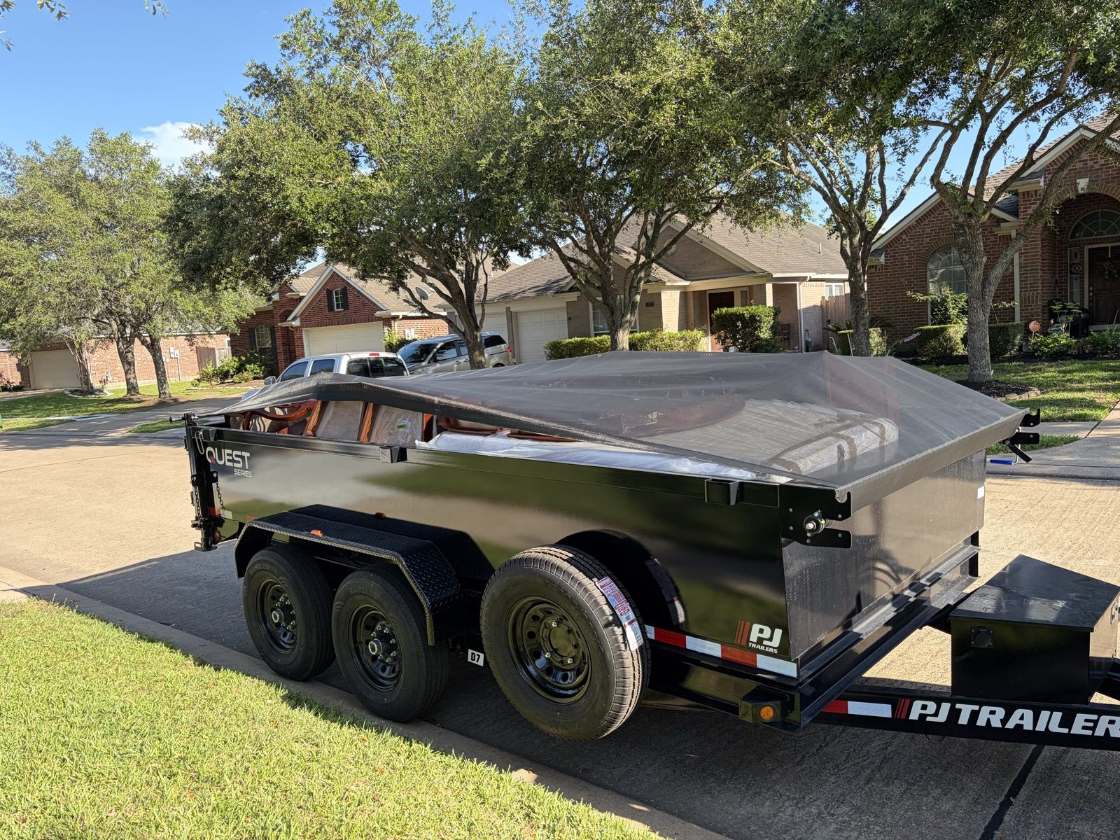 H&L dump trailer parked at a suburban home