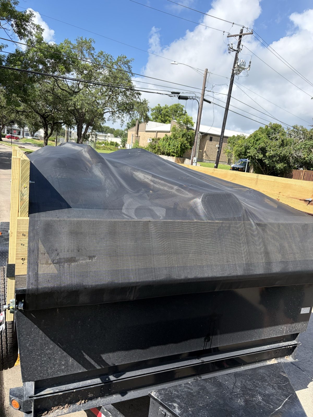 Empty H&L dump trailer bed after offloading